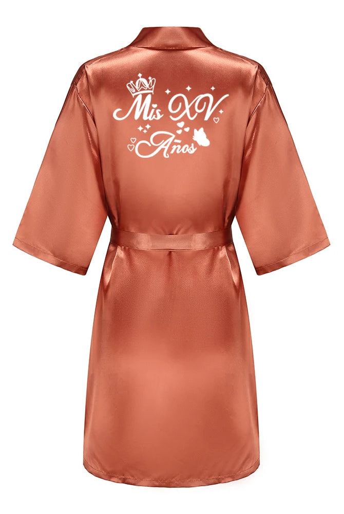 Royal blue quinceanera princess satin bathrobe with Mis XV Anos printed on back, featuring a belt and wide sleeves for girl birthday celebration.
