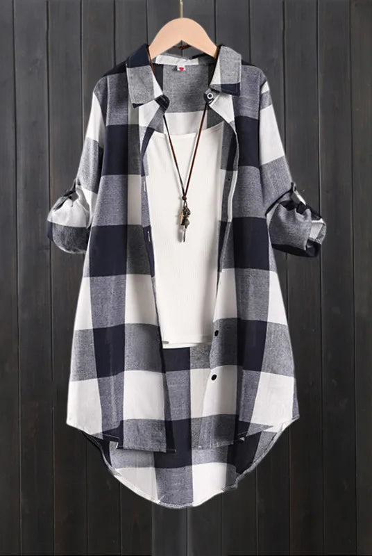 Women's plaid shirt casual blouse for women, long sleeve check linen cotton top with a white inner shirt, hanging on a wooden hanger against a dark wood background.