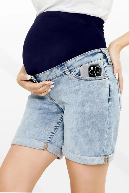 Pregnancy Capri Jeans High Waist Tummy Control Rolled Cuff Denim Shorts with a phone in the front pocket, worn by a pregnant woman.
