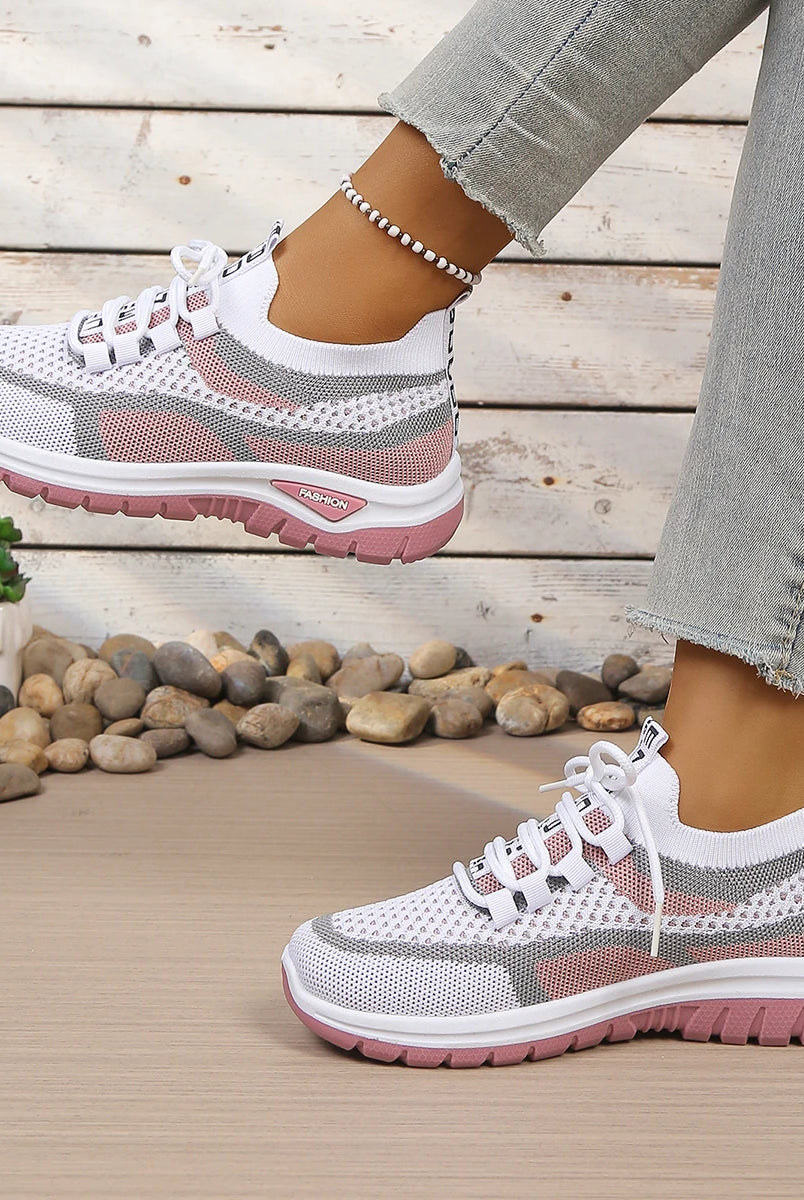 Women's summer 2026 casual sneaker with breathable mesh upper, two-tone pink and gray, soft PVC sole for comfort, worn with