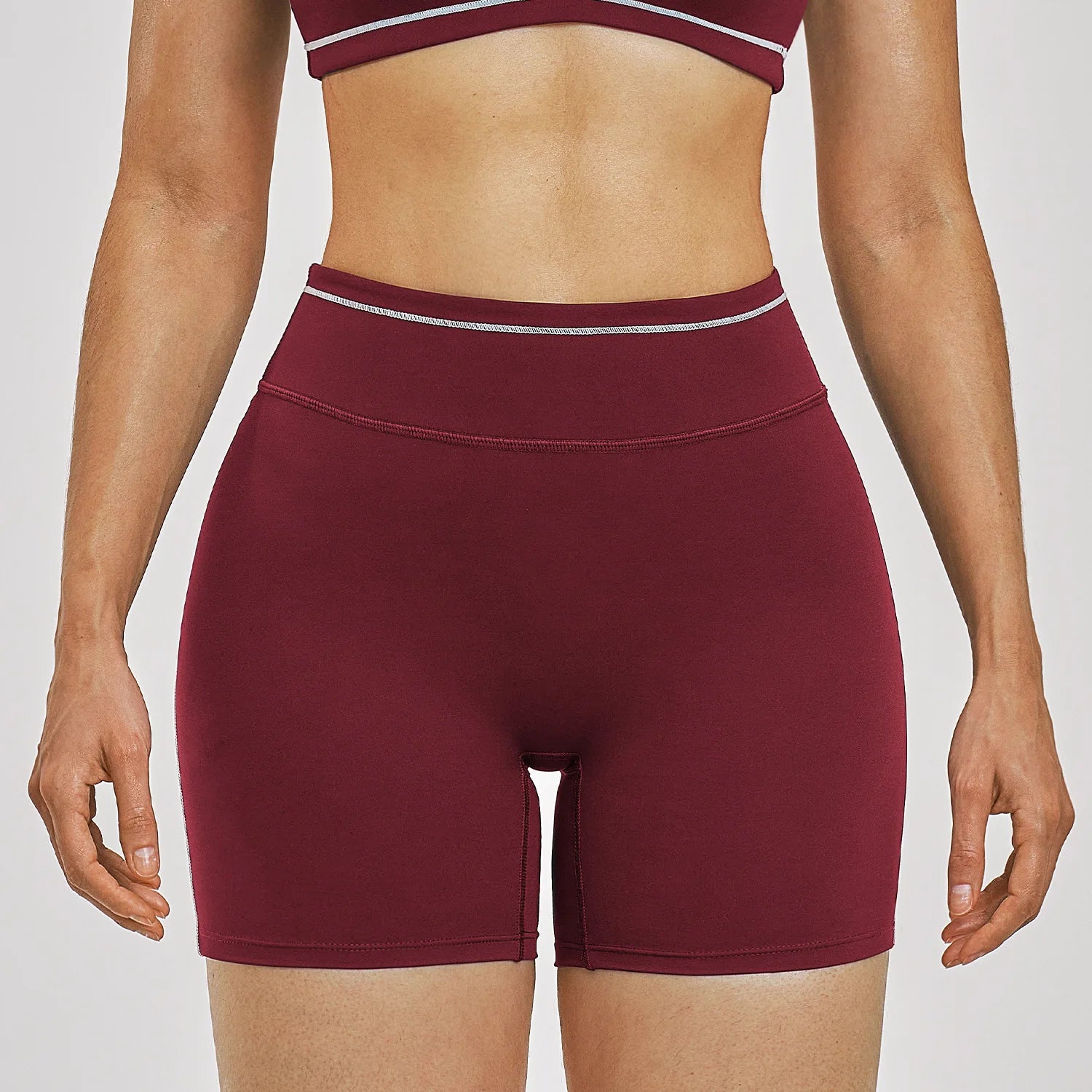 Women Running Sports Shorts Buttock Lift Gym Leggings Women Summer Shorts Cycling Slim Fit Workout Shorts High Waist Yoga Shorts in burgundy color.