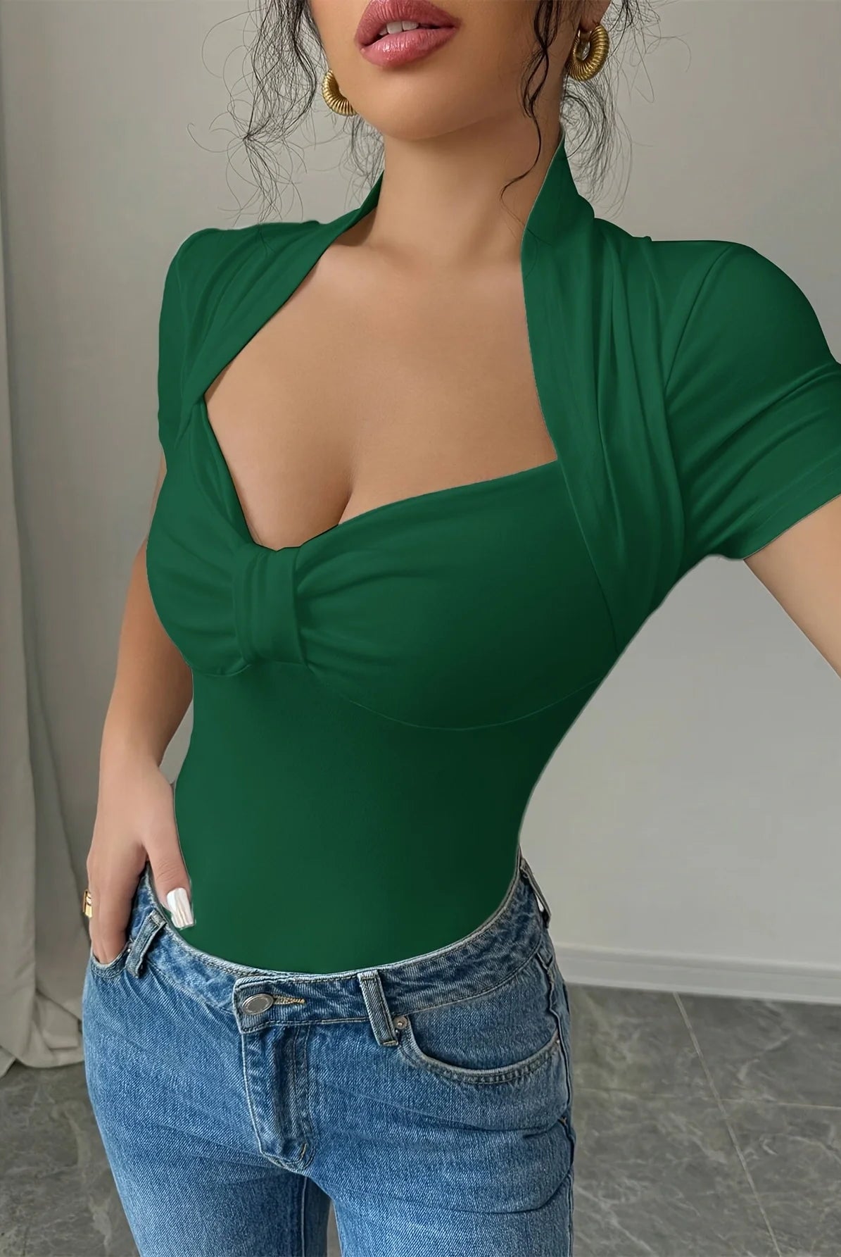 Plus Size V Neck Women T-Shirt casual short sleeve slim fit top in green with knot detail, worn with blue jeans.