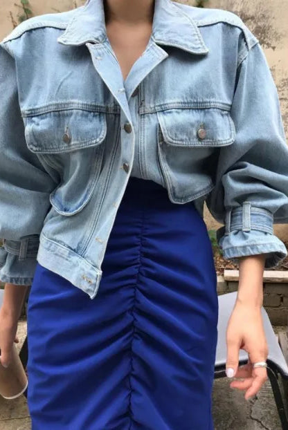 Womens cropped denim jacket with puff long sleeves from the Coats Jackets Women Top 2022 collection, styled with a blue ruched skirt.