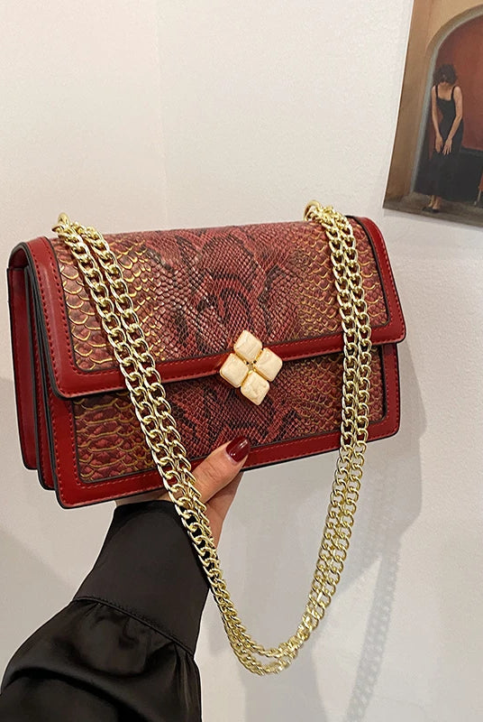 Luxury Purple Women's Single Shoulder Bag with PU leather, snake print design, gold chain strap, and decorative clasp.