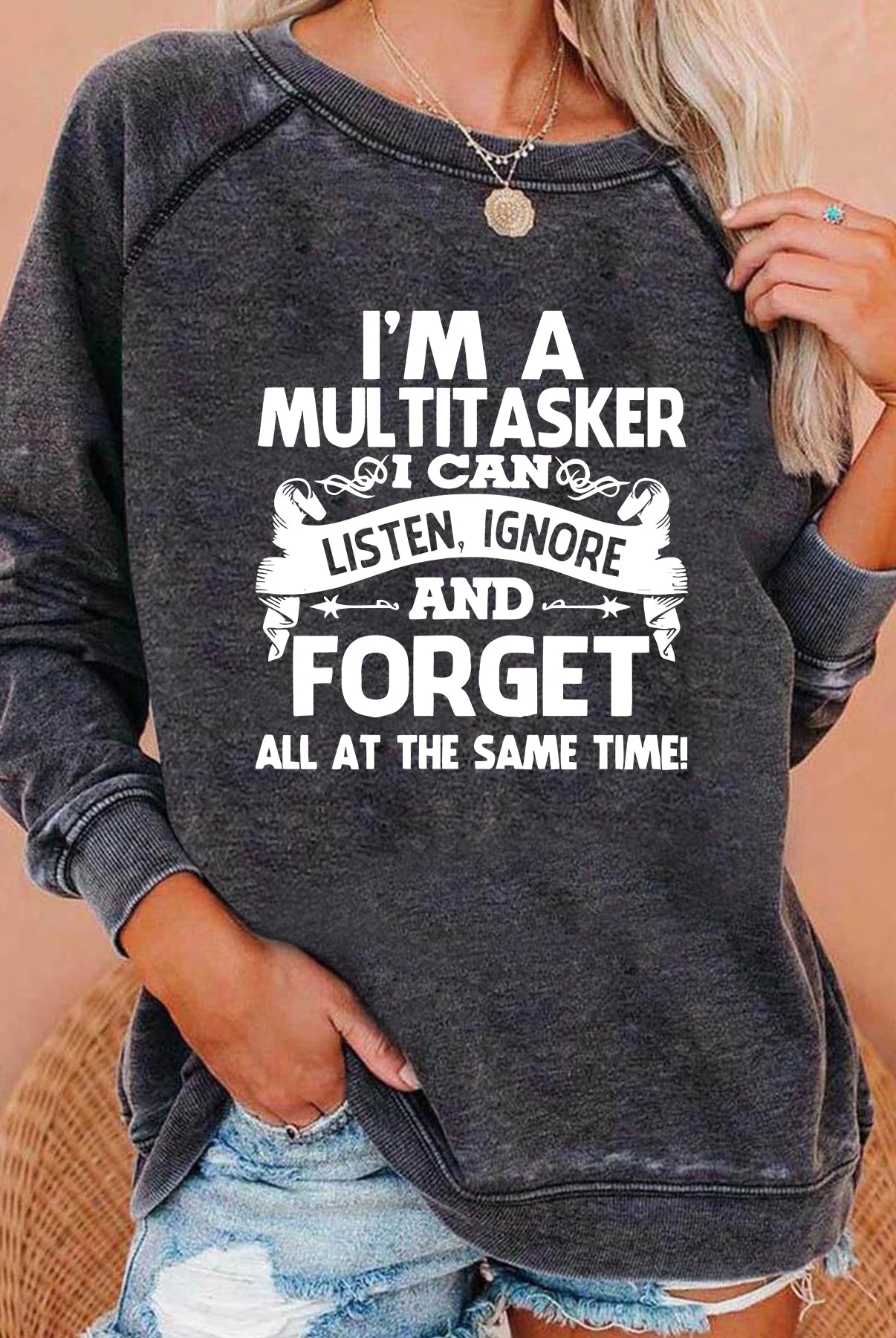 Women wearing a dark gray long sleeve sweatshirt with I'M A MULTITASKER I CAN AND FORGET printed in white, casual style for fall and winter.