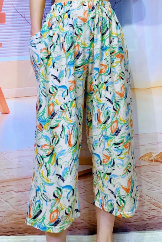 High waisted women's Capri pants with wide legs, cropped length, colorful abstract pattern, and pockets for casual summer