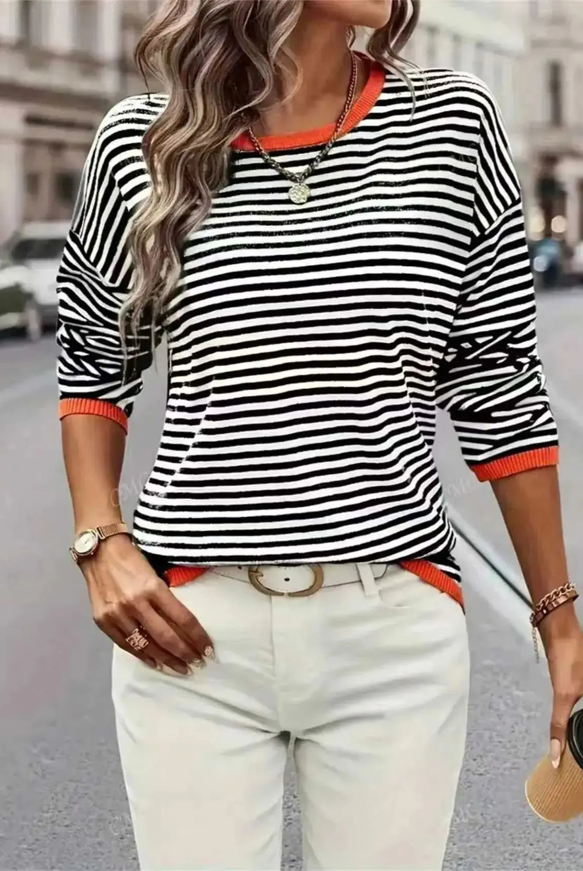 Plus-Size Women's Striped Color-Blocked Fashion Loose Sweater in black, white, and orange for autumn and winter, worn with