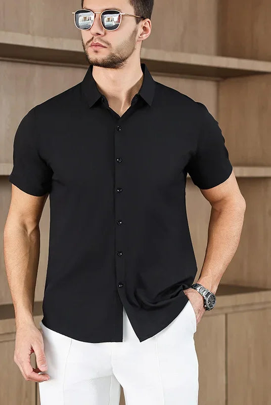 Men's business casual short-sleeved solid color shirt for summer, no iron, lightweight, versatile, worn by male model with white pants.