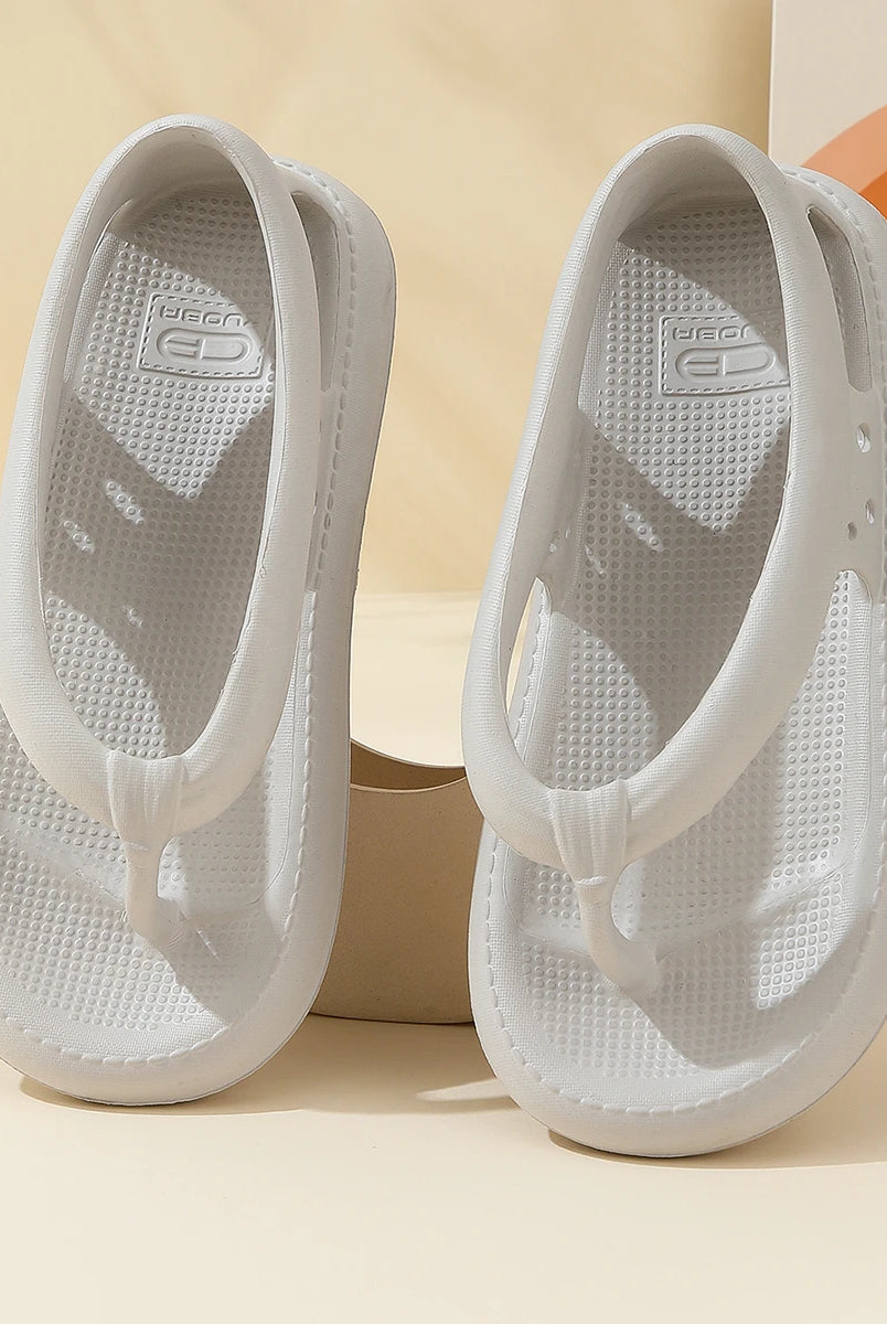 White unisex summer waterproof flip-flops with thick soles and non-slip textured footbeds for beach and outdoor wear.
