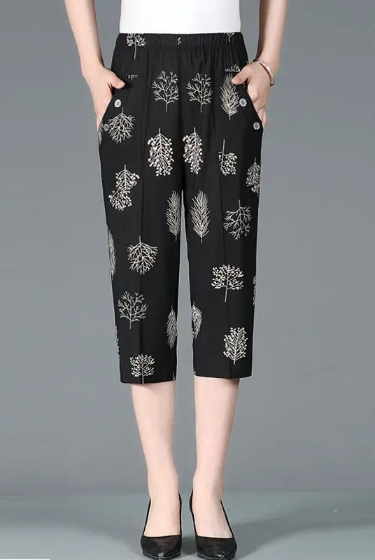 Summer new high waist Capri pants with elastic waistband, casual loose fit, black fabric with white patchwork tree prints and pockets.