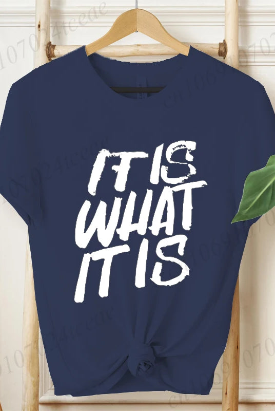 Navy blue women's T-shirt with IT IS WHAT IT IS in bold white graphic text, short sleeves, casual summer fashion tee