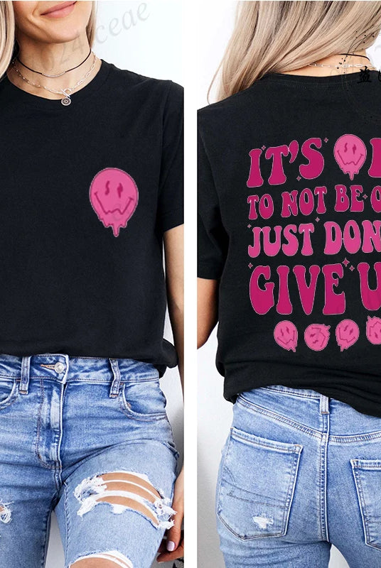 Casual black T-shirt for women with It's OK to Not Be OK Just Don't Give Up message in pink text and graphics, paired with