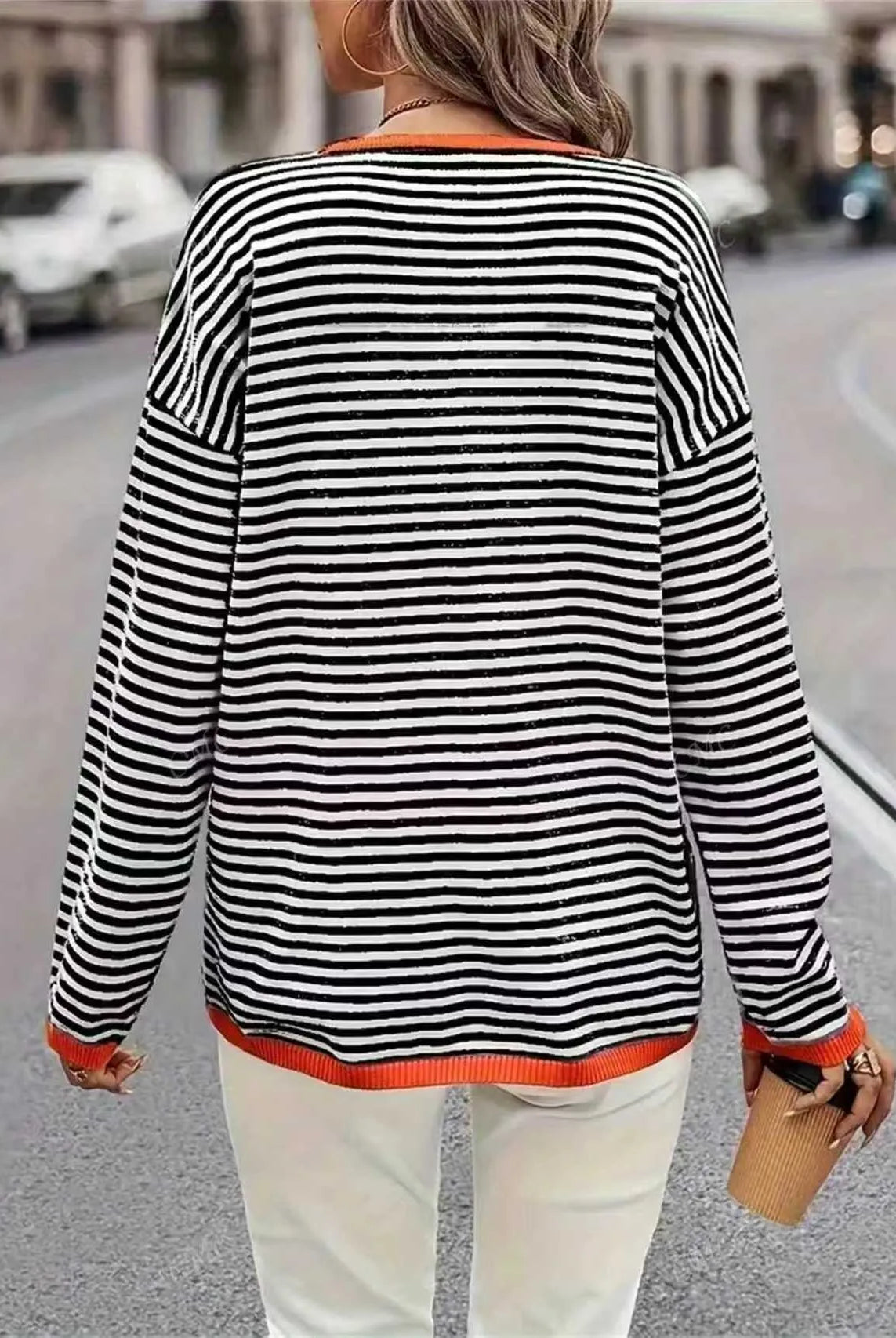 Plus-Size Women's Striped Color-Blocked Fashion Loose Sweater with black and white horizontal stripes, orange trim, worn in