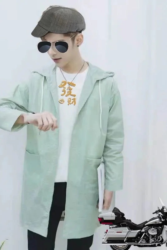 Summer lightweight men's windbreaker outdoor beachwear sun protection long coat in light green with hood, worn by a male
