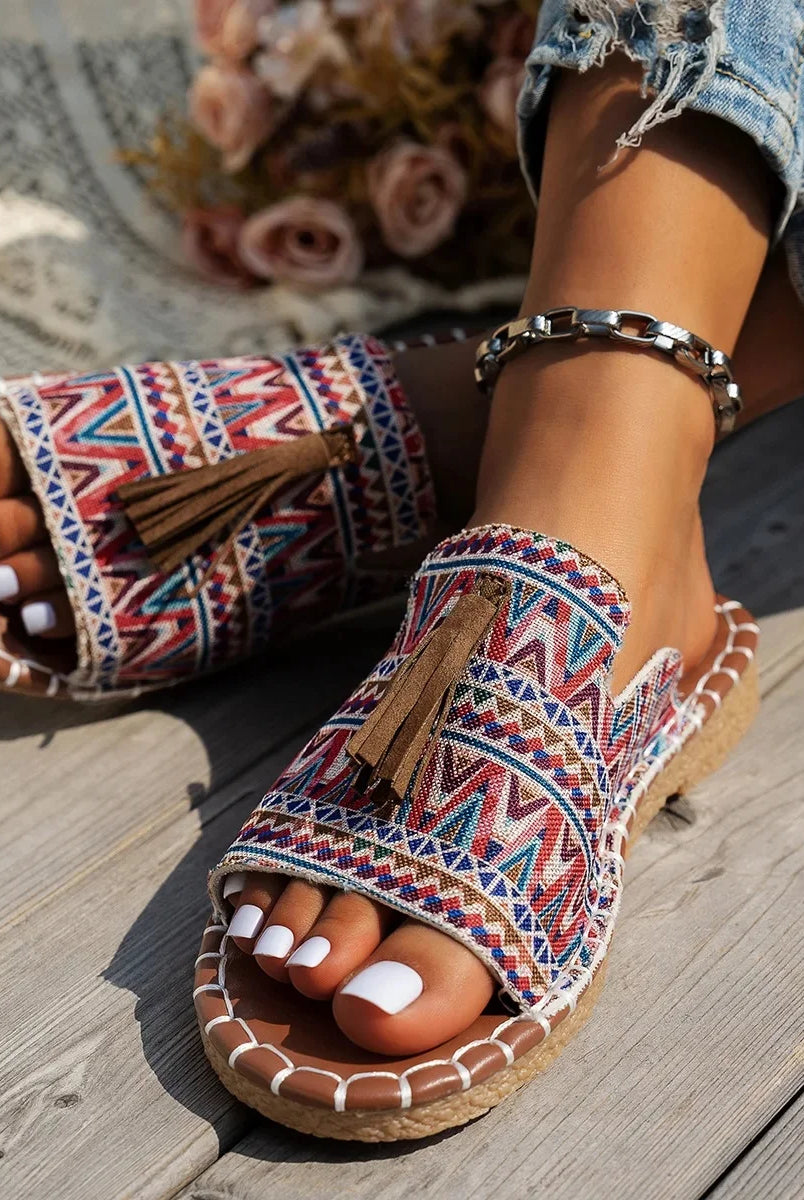 Bohemian flat bottom slippers women's outdoor summer sandals with colorful tribal pattern, tassel accents, and cushioned sole.