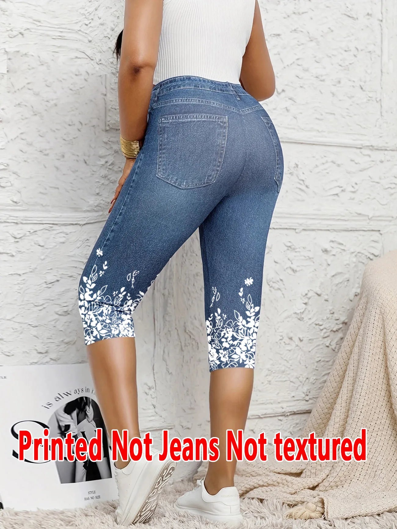 Ladies' Seven-Point Printed Leggings with faux denim print, not textured or jeans-like, white floral design at the hem, casual wear.