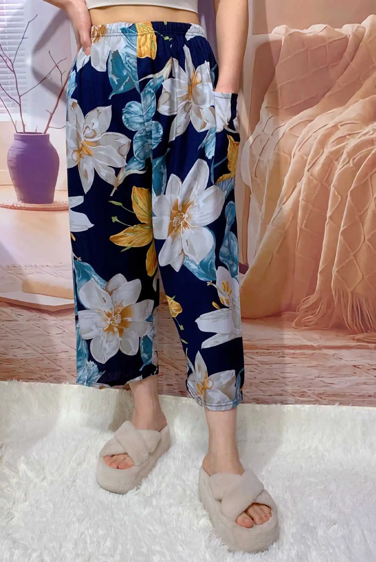High waisted women's Capri pants with a floral print, wide leg, cropped length, casual lounge style, with pockets in navy