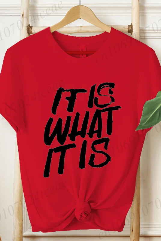 Red women's IT IS WHAT IT IS design shirt with bold black graphic text, short sleeves, knotted front, casual summer fashion