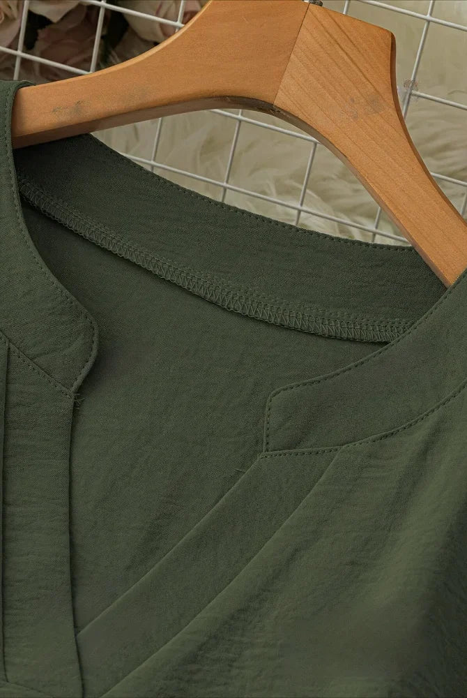 Plus Size 2025 New Casual Tops Women's Loose Long Sleeve Stand Collar T-shirts in dark green polyester fabric hanging on a