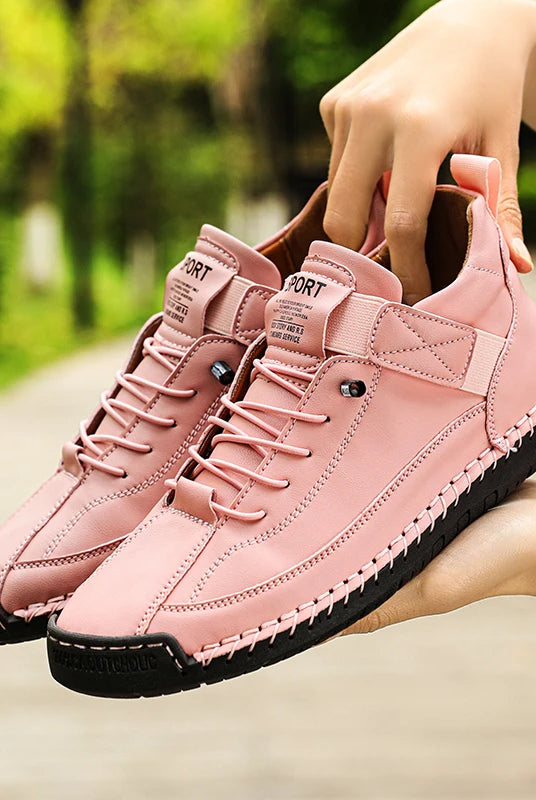 Pink handmade leather women's mid-top casual sneakers with black sole, slip-on loafers style, suitable for everyday wear.