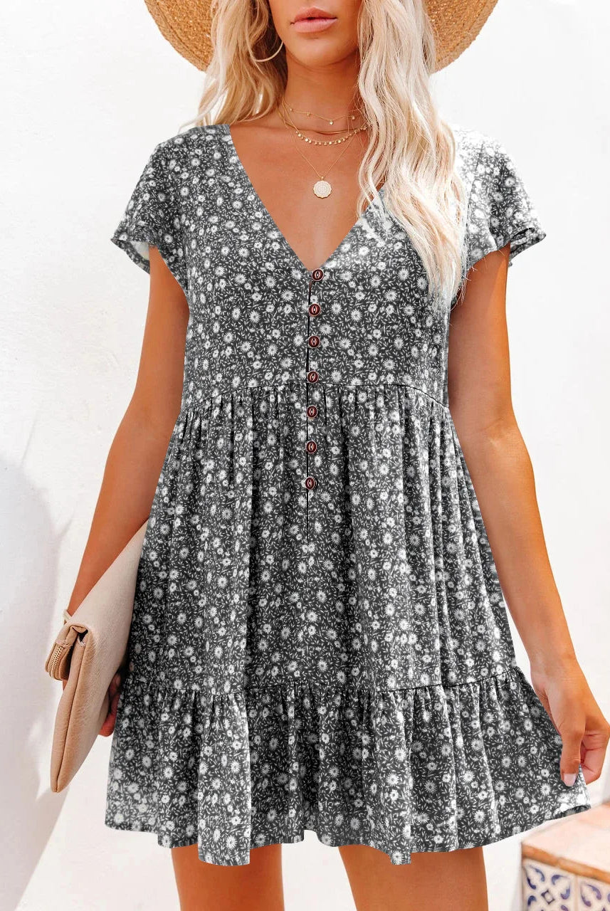 Spring and summer women's leisure dress with V-neck, button front, small floral pattern, loose fit, short sleeves, and tiered skirt.