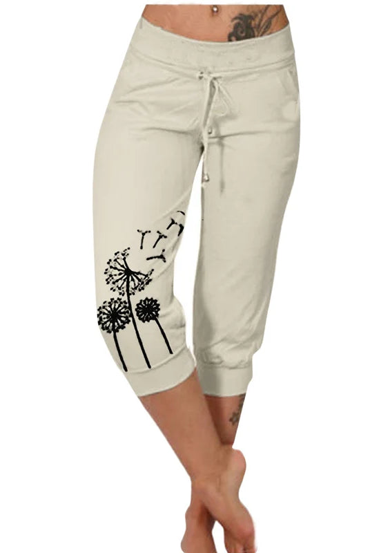 Fashion Mid-calf Lady Capri Pants 2023 Summer drawstring pockets cropped pants women sports shorts for outdoor Pantalones, beige with black dandelion print.