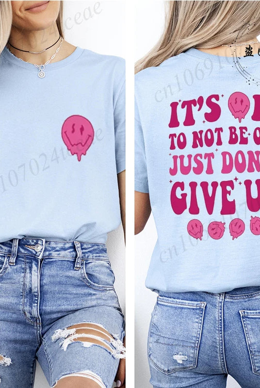 Casual Women's T-shirt in light blue with pink motivational message It's OK to Not Be OK Just Don't Give Up and a pink skull