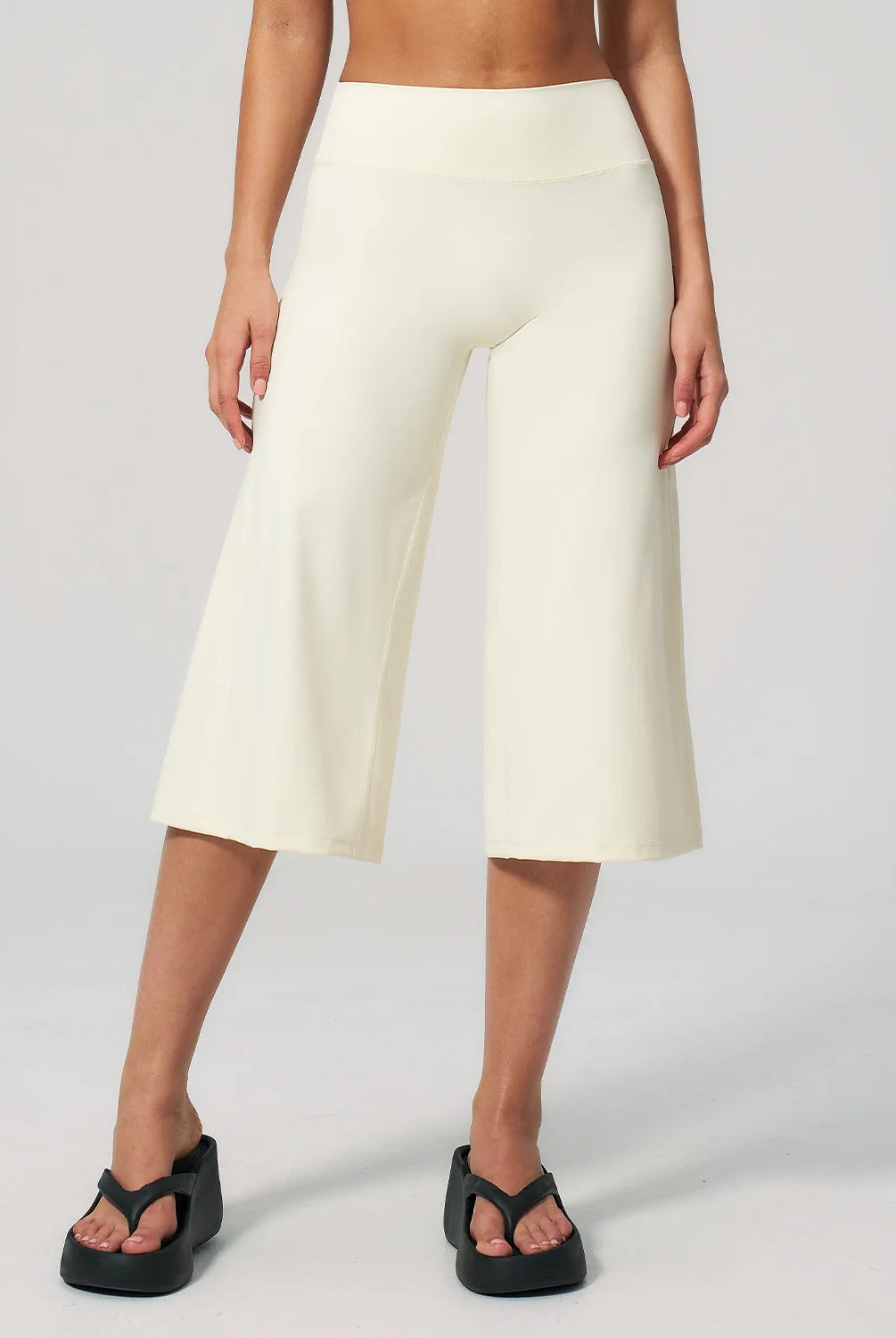 Summer Capri Pants for Women Wide Leg Yoga Cropped Pants Tummy Control High Waist in Flare Crop, buttery soft, loose casual style, worn with black platform sandals.