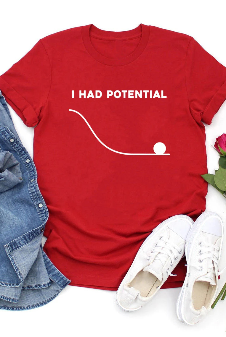 Red I Had Potential T-shirt with golf ball graphic, casual style, paired with denim jeans, white sneakers, and pink roses.
