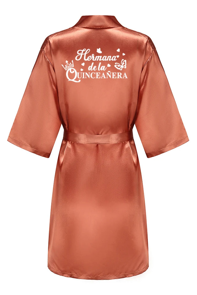 Royal blue satin Quinceanera robe with embroidery on the back, designed for a princess-themed 15th birthday celebration.