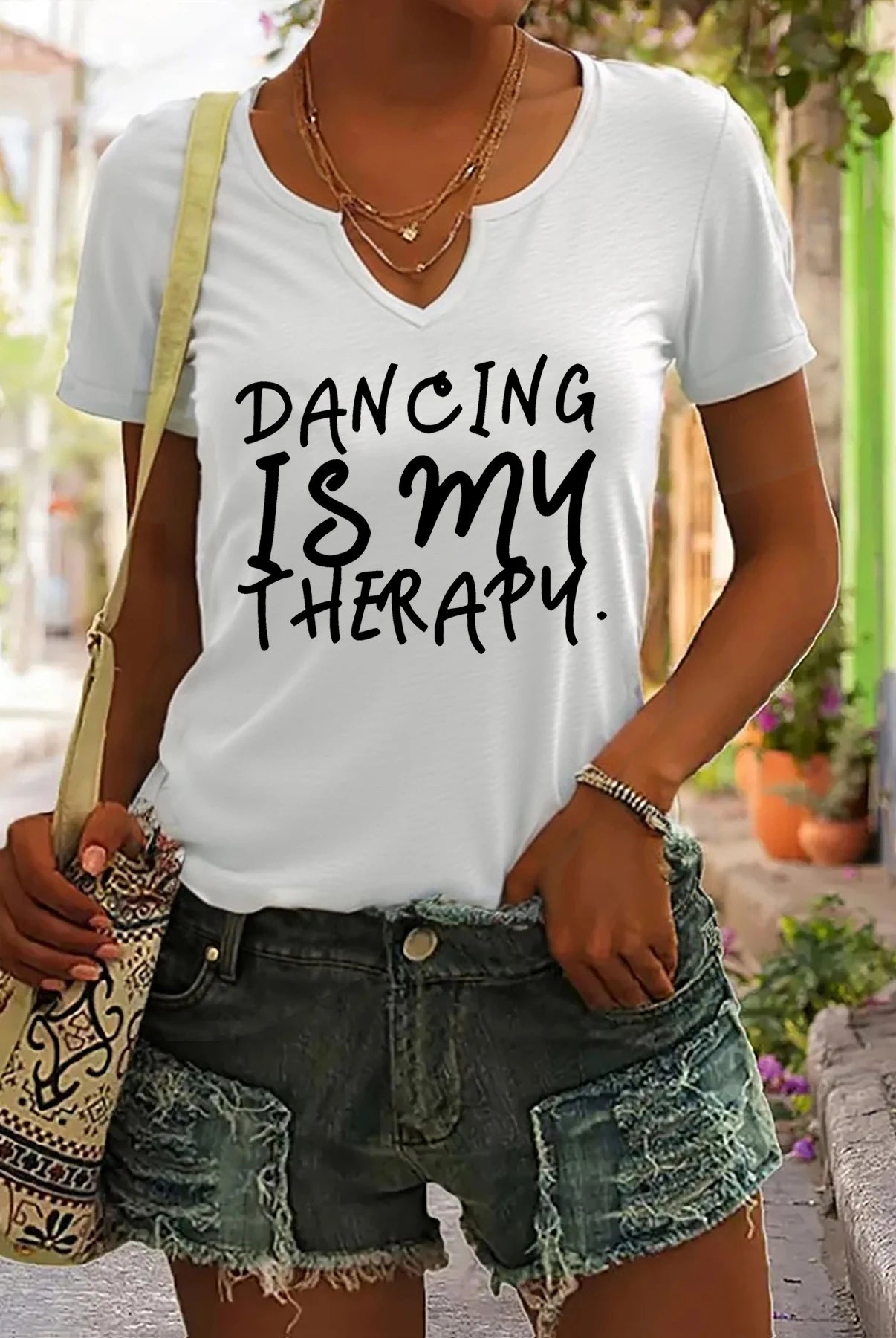 Women's white summer V-neck short sleeve T-shirt with Dancing Is My Therapy slogan, casual dance lover top, worn with denim
