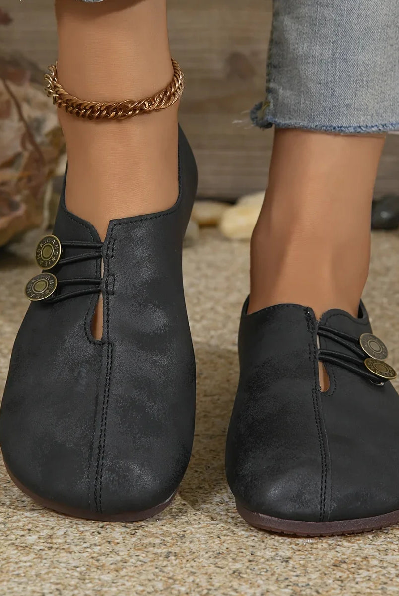 Comfortable soft sole round toe flats shoes for women in black with buckle decoration, casual breathable slip-on design, worn with rolled-up jeans.