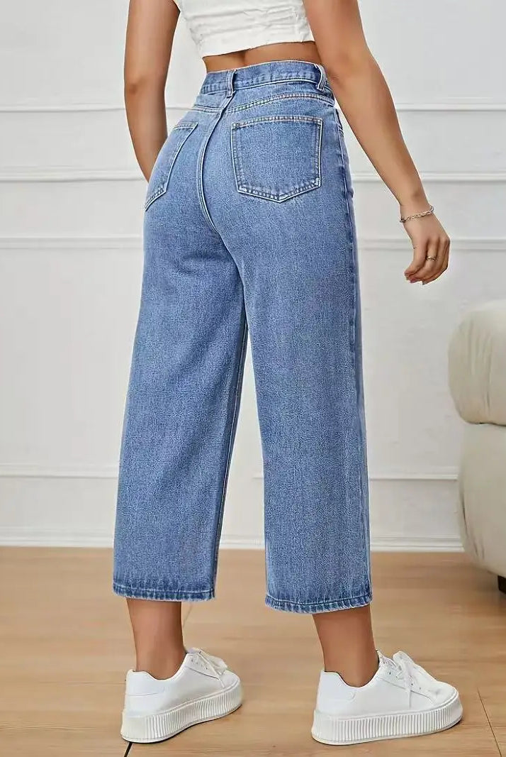 Women's High-Waisted Wide-Leg Capri Jeans in light blue denim with back pockets, styled with white sneakers and a white crop