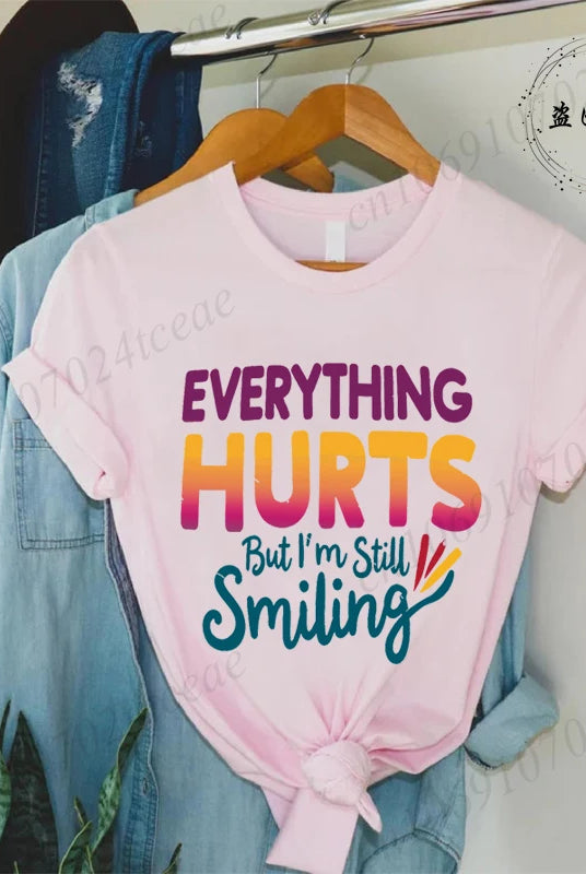 Pink cotton short sleeve T-shirt with colorful Everything Hurts But I'm Still Smiling quote, part of the Funny Sarcastic