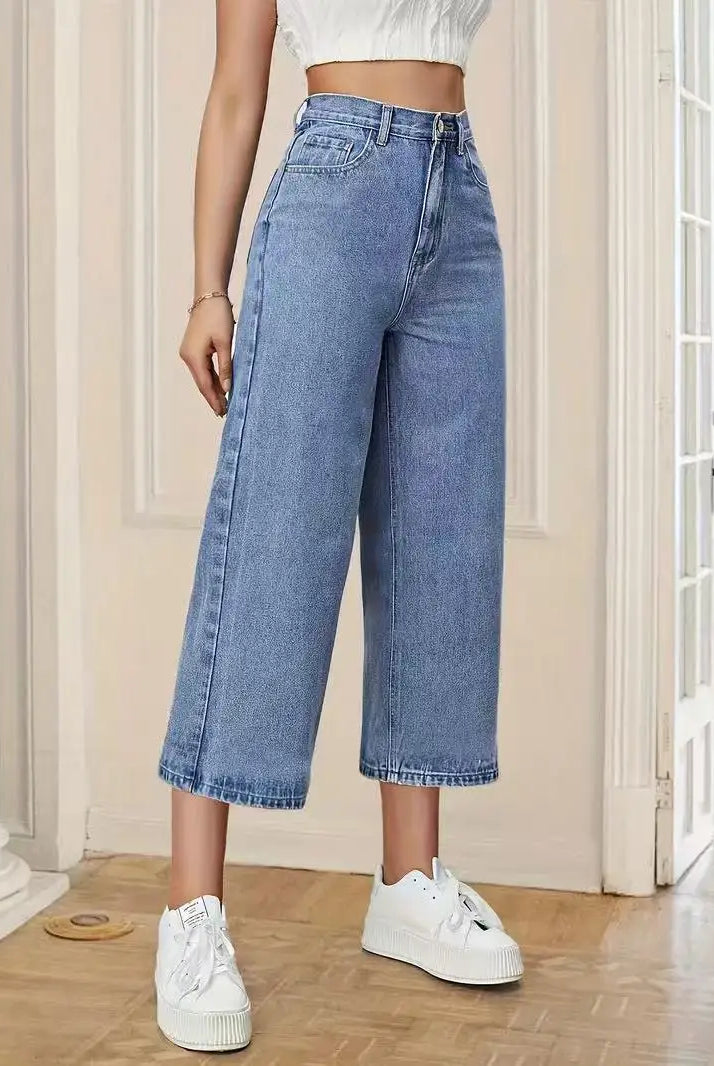 Women's High-Waisted Wide-Leg Capri Jeans in light blue denim with relaxed fit, cropped length, paired with white sneakers.