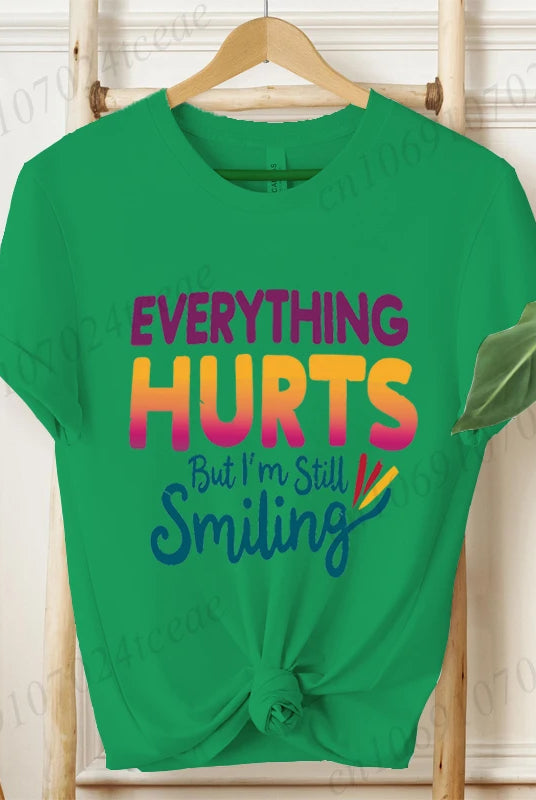 Green short sleeve T-shirt with Everything Hurts But I'm Still Smiling funny sarcastic quote design, casual summer fashion