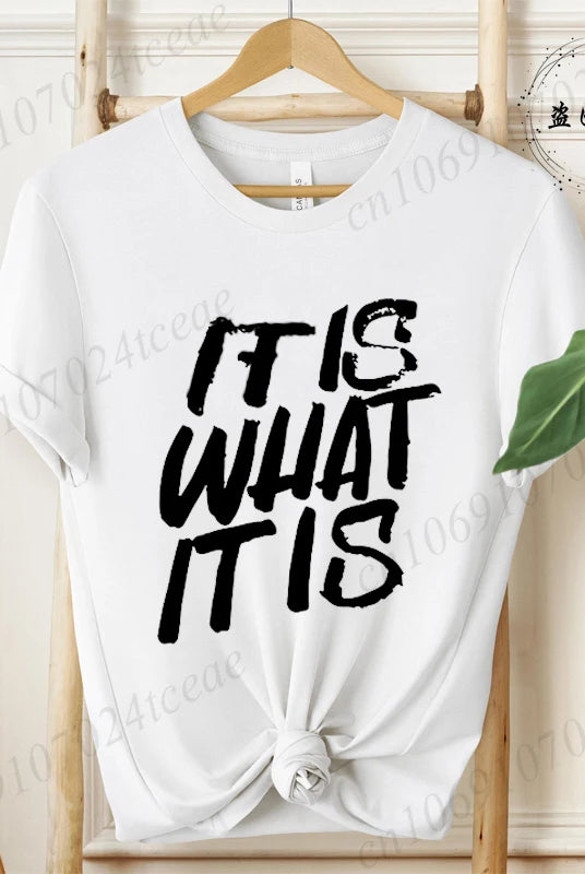 White women's T-shirt with IT IS WHAT IT IS sarcastic quote graphic, short sleeves, casual summer fashion tee.