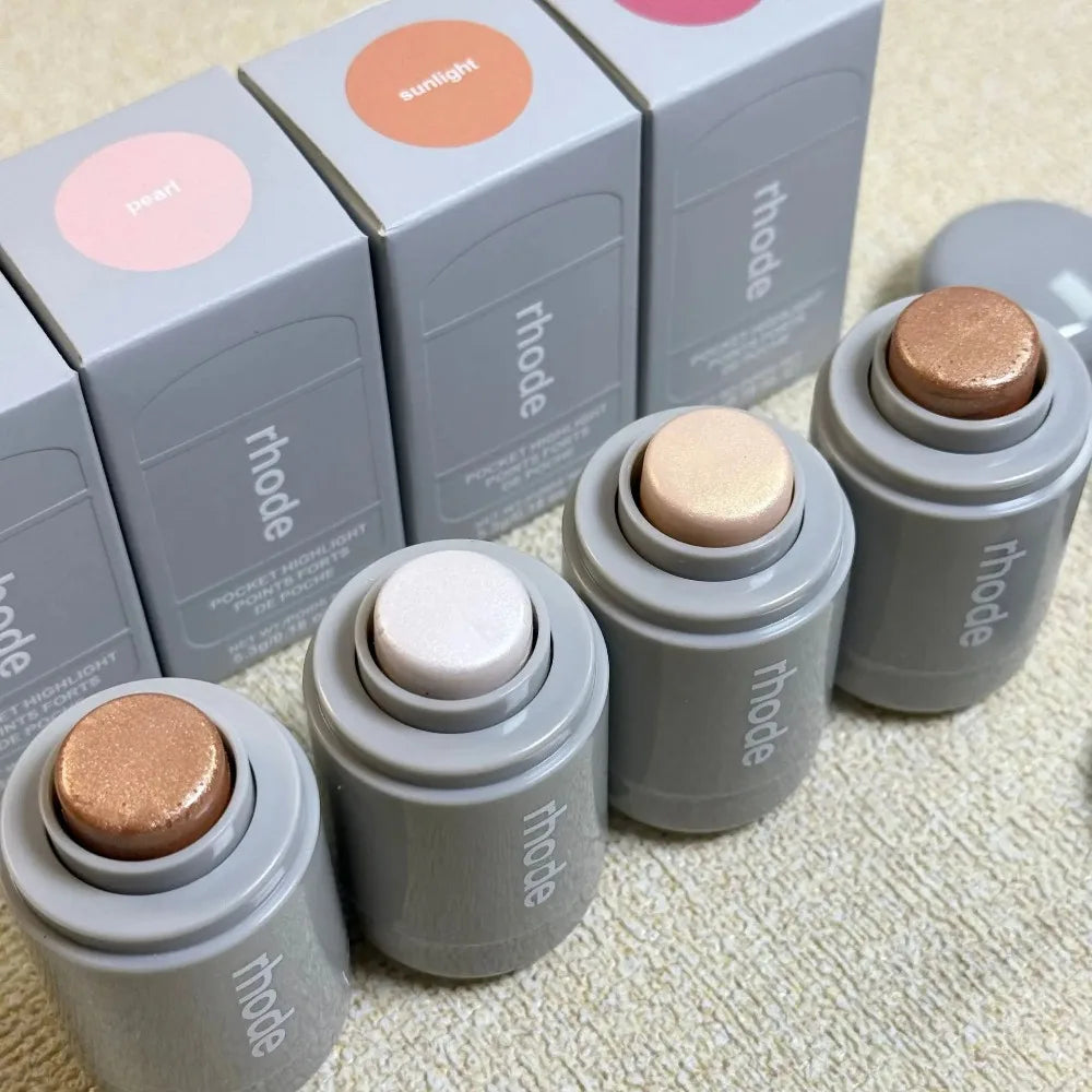 Rhode Highlight Stick set with four shades: pearl, sunlight, rose, and bronzo, featuring glossy, brightening, and shimmery