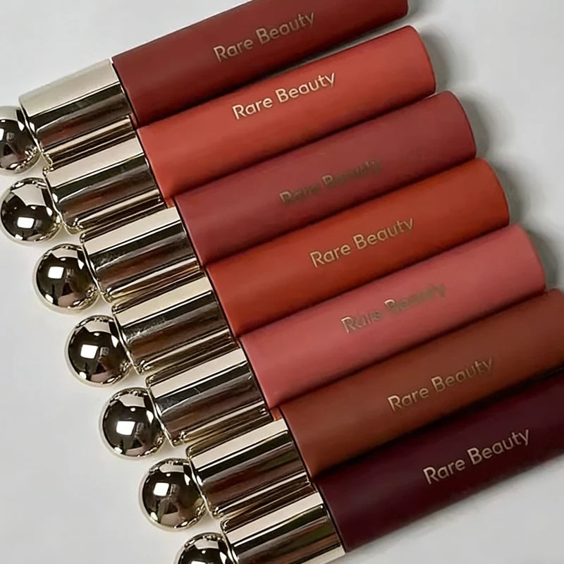 Rare Beauty 7-Colors Soft Pinch Tinted Lip Oil Stain Lip Gloss set with metallic caps in shades of pink, coral, mauve, and