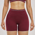 Women Running Sports Shorts Buttock Lift Gym Leggings Women Summer Shorts Cycling Slim Fit Workout Shorts High Waist Yoga Shorts in burgundy color.