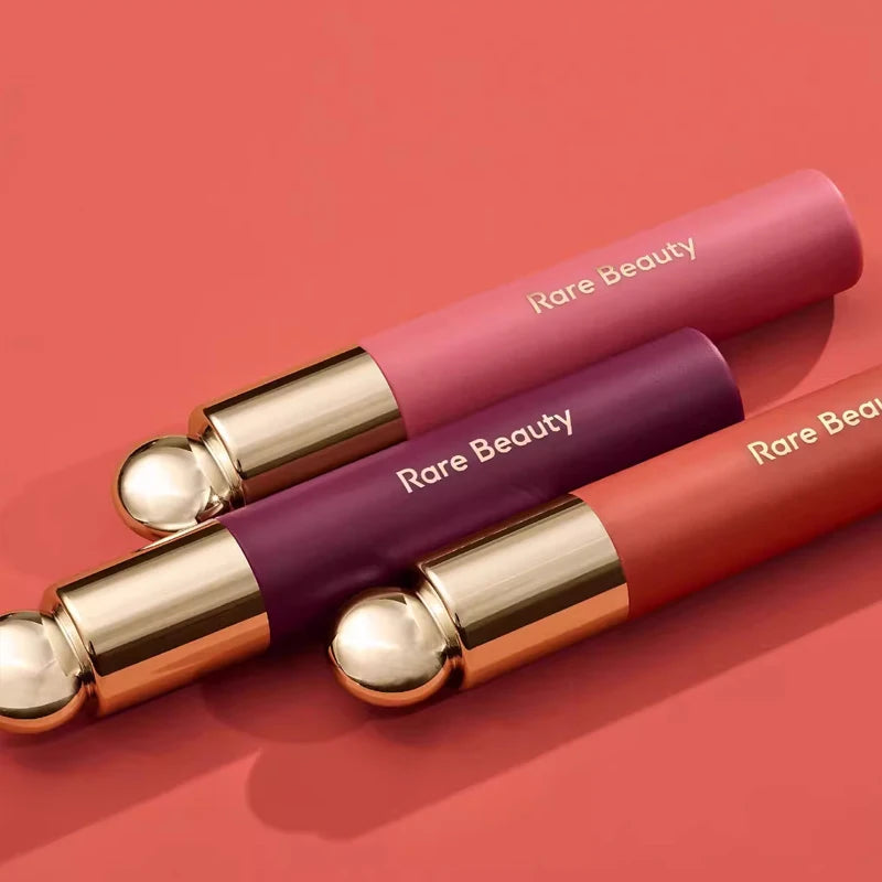 Rare Beauty 7-Colors Soft Pinch Tinted Lip Oil Stain Lip Gloss in pink, purple, and coral shades with gold accents and