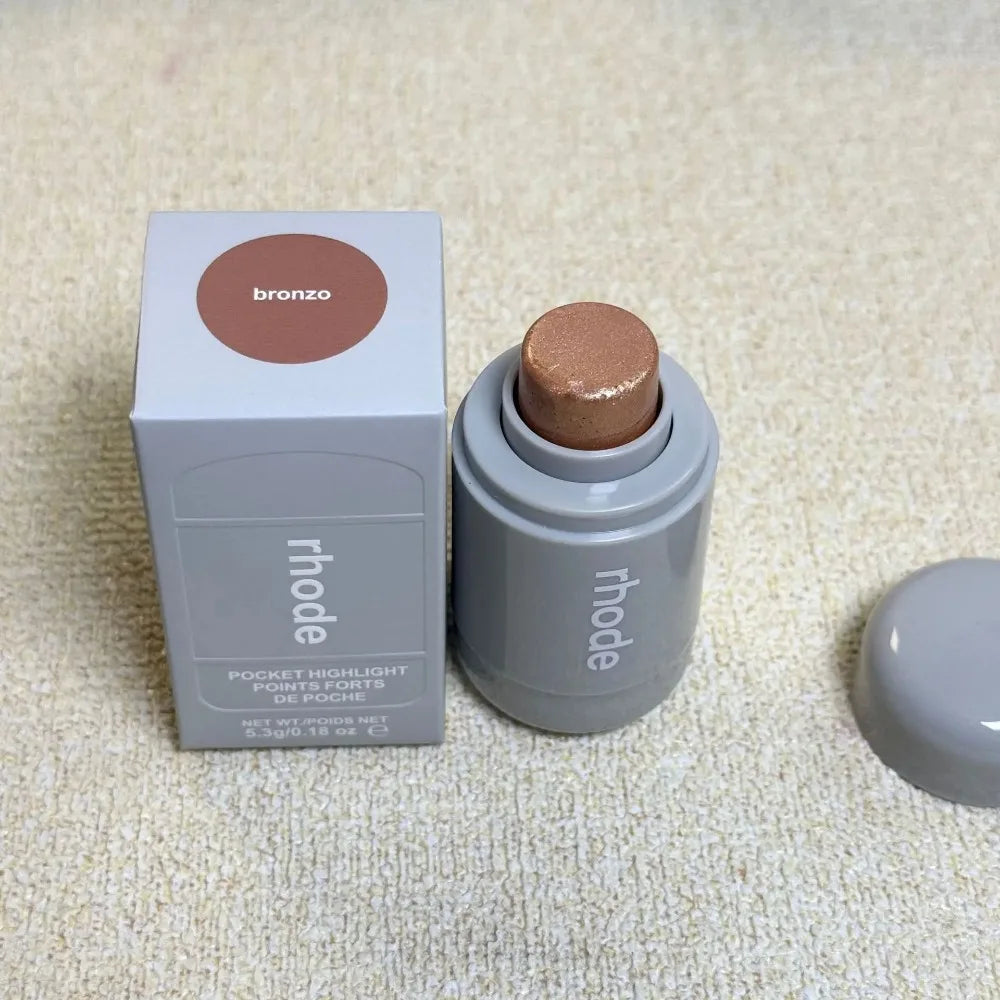 Rhode Highlight Stick in bronze, sunlight pearl, and rose shades with a glossy finish, designed for brightening cheeks and