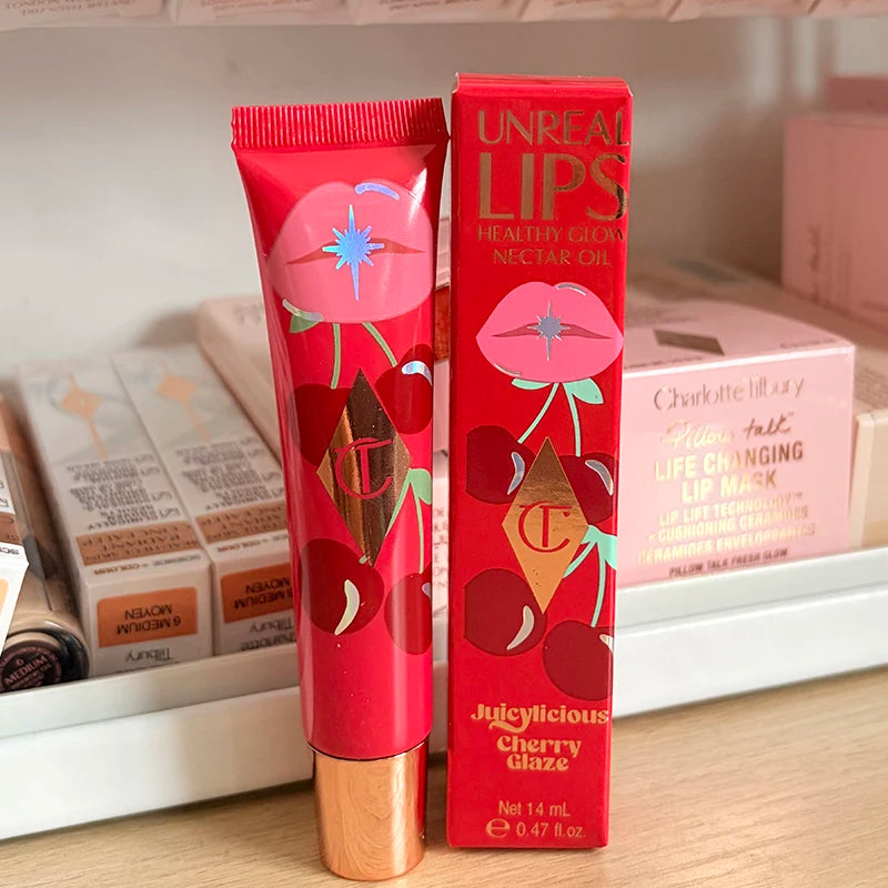 Charlotte Tilbury Juicylicious Cherry Glaze moisturizing lip gloss in a pink and red tube with cherry and lips illustrations.