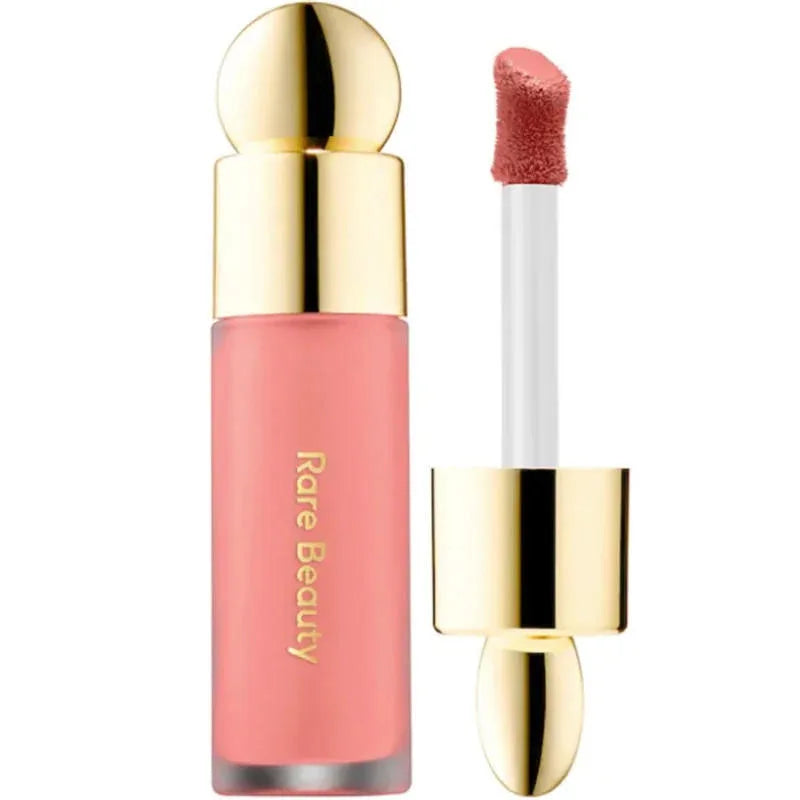 Rare Beauty Soft Pinch Liquid Blush in pink with a gold cap and applicator, designed for a silky, long-lasting, and smooth plumping makeup look.