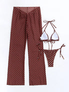 Three-piece women's swimsuit cover-up set including high-waist pants and backless bikini top and bottom with a red and gold