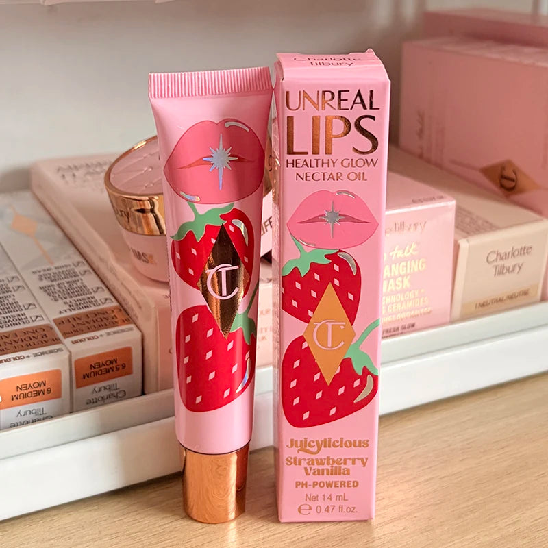 Charlotte Tilbury UnreAL Lips Strawberry Vanilla moisturizing lip gloss in pink packaging with strawberry and vanilla