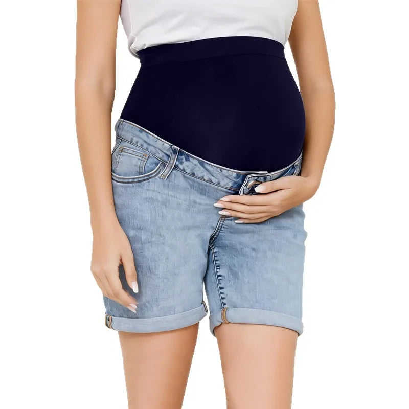 Pregnancy Capri Jeans High Waist Tummy Control Rolled Cuff Denim Shorts worn by pregnant woman with hand on belly, light blue denim, rolled cuffs.