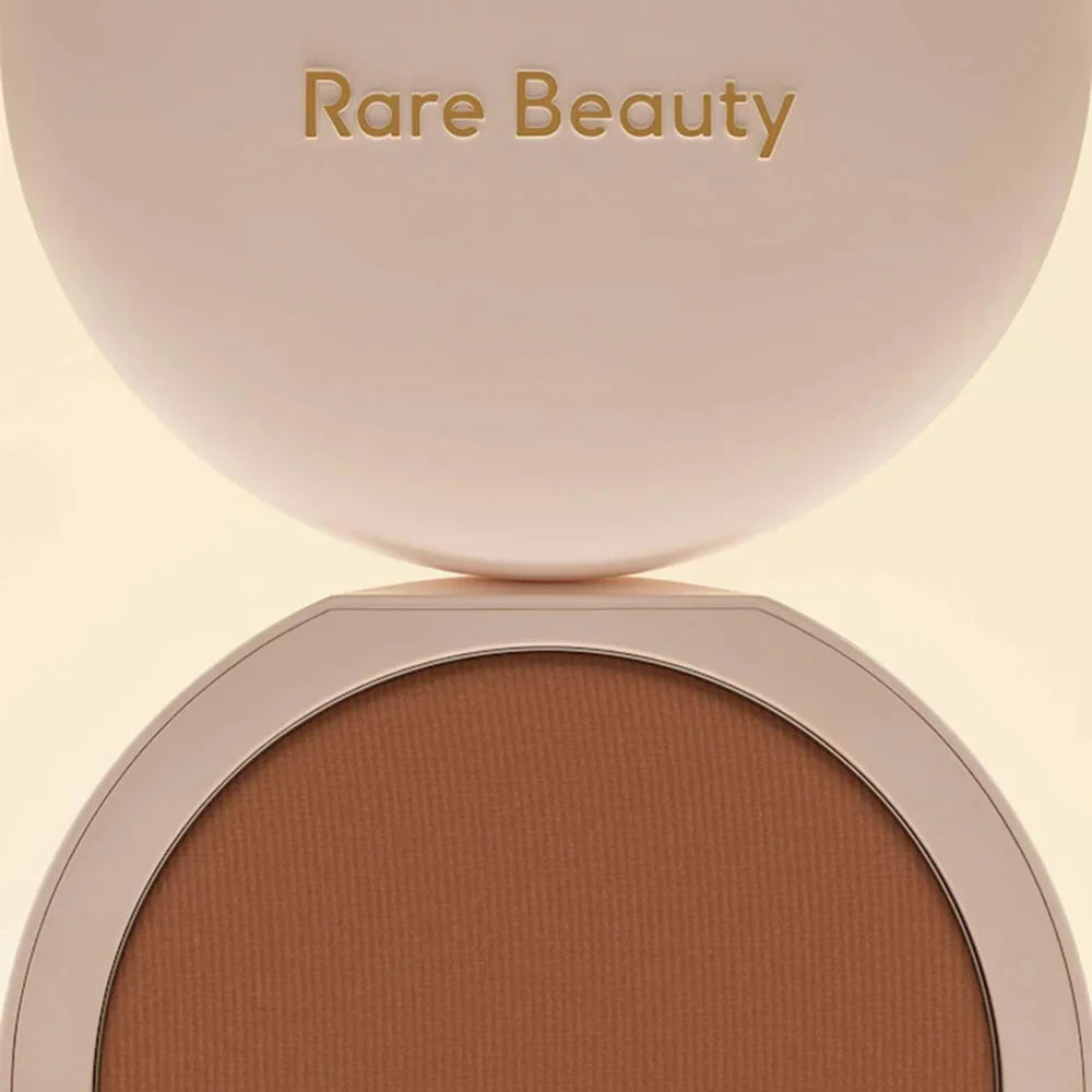 Rare Beauty Stay Genuine Shaded Compact Setting Powder in a beige case with warm brown pressed powder for oil control and a