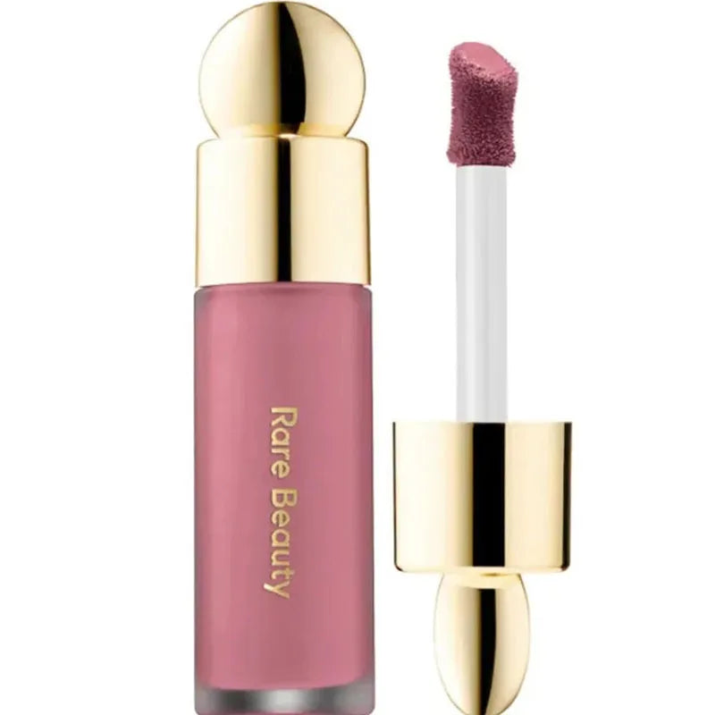 Rare Beauty Soft Pinch Liquid Blush in soft pink with a gold cap, silky texture, glides smoothly, long-lasting, for a plump natural glow.
