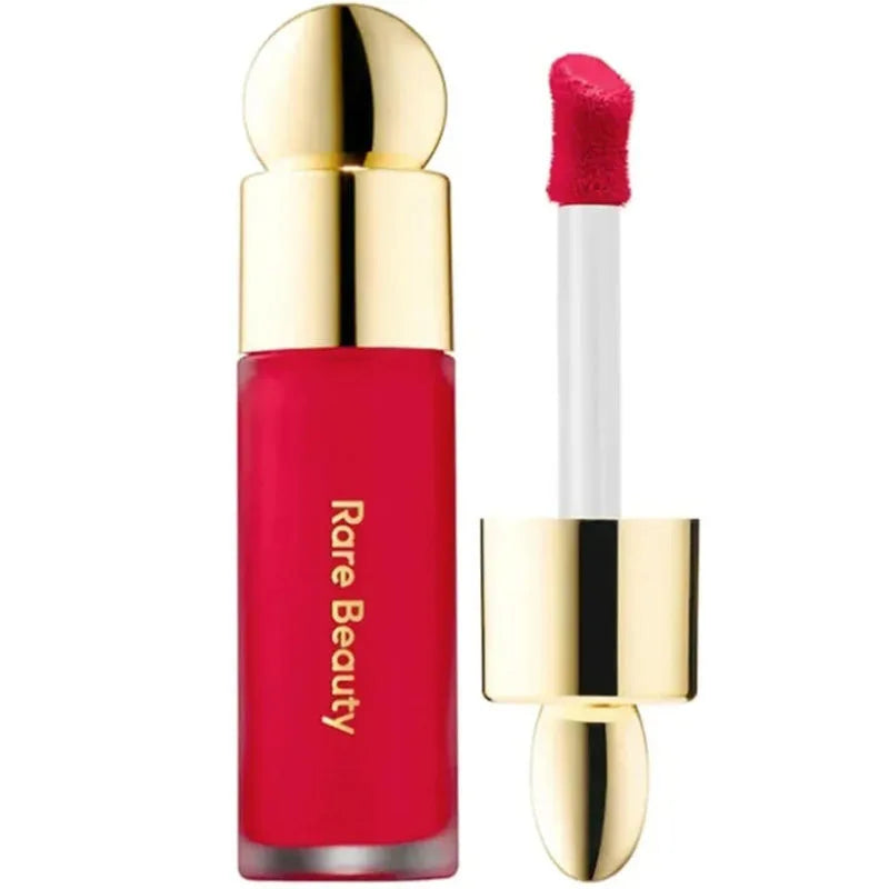 Rare Beauty Soft Pinch Liquid Blush in vibrant pink with gold cap and applicator wand, designed for a silky, long-lasting, and smooth finish.
